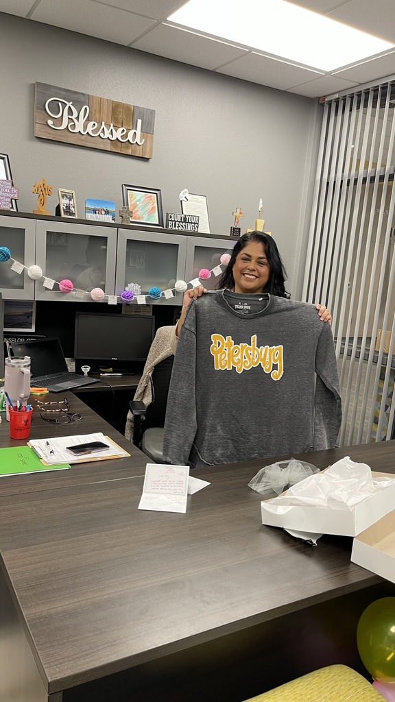 Mrs. Reyes receives a Petersburg sweater as a gift for Counselor's Week!